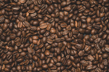 Texture of roasted aromatic brown coffee beans.