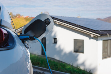 Charging an electric car in home,sustainable transportation concept.