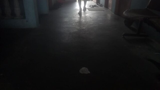 person walking in the dark room