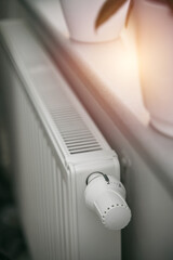 Decreasing radiator heat. Saving energy in winter. Concept of a tips list to have lower utility bills.
