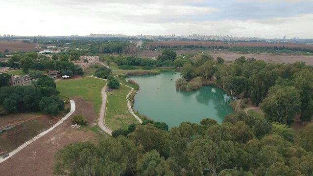 Aerial view over a beautiful lake with fortress ruins in the background  - Tel Afek National Park #009