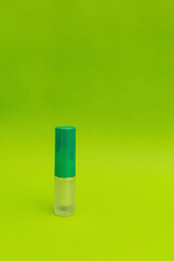 Green lipstick on green background, monochrome