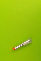 Green lipstick on green background, monochrome