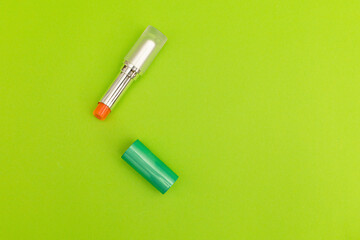 Green lipstick on green background, monochrome