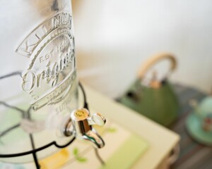 Closeup of empty liquid dispenser jar on wooden table