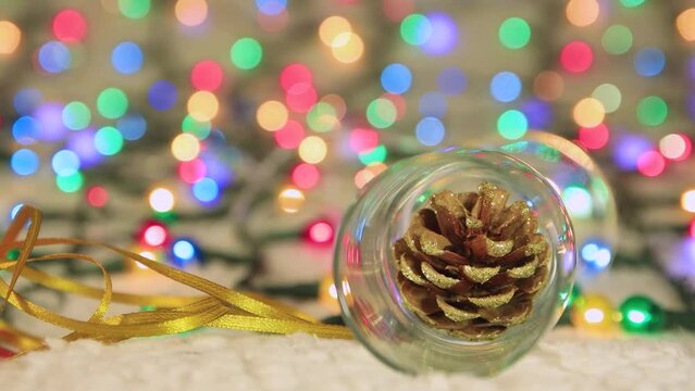 Salt cone in an empty champagne glass against the backdrop of Christmas lights. Place to copy. New Year multi-colored lights in defocus. Beautiful holiday card, video for intro, text, intro. UHD 4K.