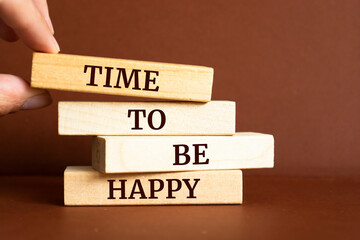 Wooden blocks with words 'Time to be happy'.