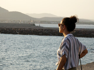 Determined woman, looking at the horizon. New challenges. Port background