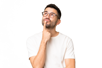 Young handsome caucasian man over isolated chroma key background having doubts while looking up