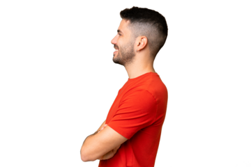 Young handsome caucasian man over isolated chroma key background in lateral position