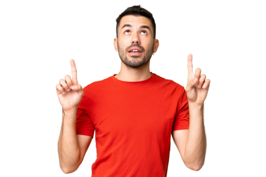 Young handsome caucasian man over isolated chroma key background surprised and pointing up