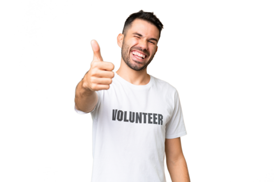 Young volunteer caucasian man over isolated chroma key background with thumbs up because something good has happened