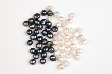 Black and white pearl on white background top view. Natural freshwater pearls