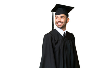 Young university graduate man over isolated chroma key background with arms crossed and happy