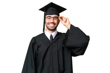 Young university graduate man over isolated chroma key background with glasses and happy