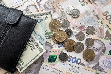 ukraine money hryvnia with us dollar bills with purse on desk