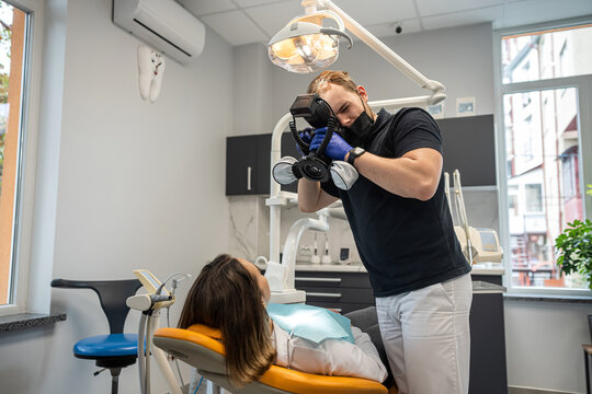 dentist takes pictures of the patient's teeth to check the results at the end.