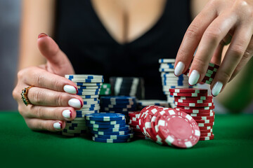 woman in dress wins a game of blackjack and is happy with all the chips after playing poker.