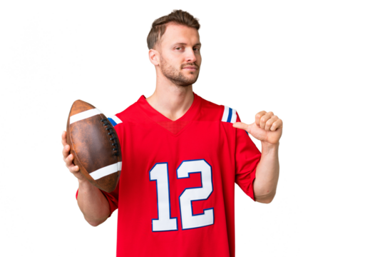 Young caucasian man playing rugby over isolated chroma key background proud and self-satisfied