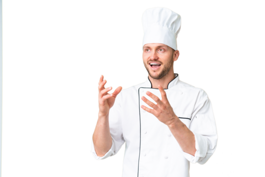 Young caucasian chef over isolated chroma key background with surprise facial expression