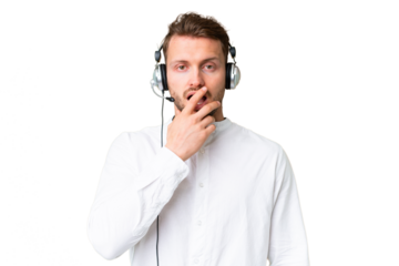 Telemarketer caucasian man working with a headset over isolated chroma key background surprised and shocked while looking right