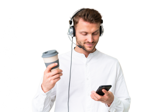 Telemarketer caucasian man working with a headset over isolated chroma key background holding coffee to take away and a mobile