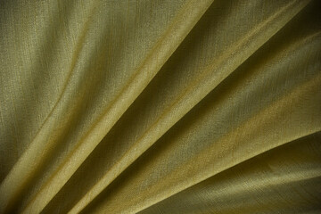 glitter gloden fabric silk texture, and dark yellow fashion clothes sheet, useful for background, wallpaper, premium cotton design.