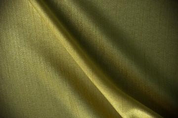 Golden folding silk, cottons, cloth textiles, fabric background design.