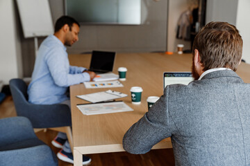 Two multiethnic businessmen working together in office