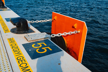 Concrete pier with yellow designations close up