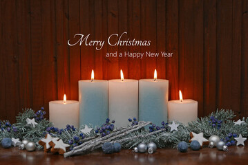 Christmas card: composition with candles, Christmas decorations, fir branches and the text Merry Christmas and Happy New Year.