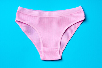 Women's panties on a blue background in studio