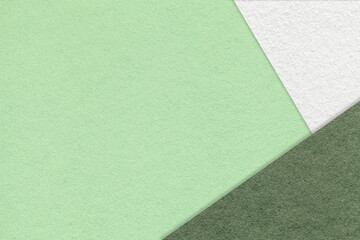 Texture of craft light green color paper background with white and olive border. Vintage abstract mint cardboard.