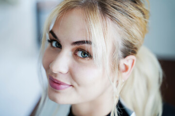 Smiling beautiful blond woman in salon