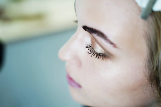 Woman with golden eyeshadow on eyelid
