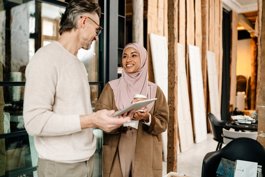 Two multiracial colleagues while working together in modern office