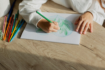 Girl drawing a picture at table