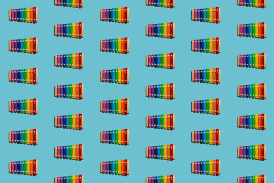 Pattern of colorful xylophones flat laid against blue background
