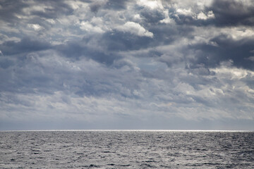 Fototapeta premium seascape with dark clouds and light