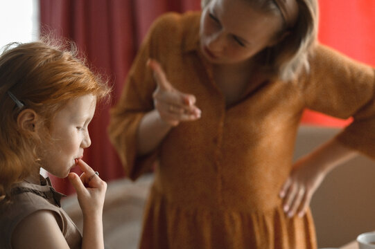 Mother scolding daughter at home
