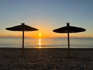 Parasol with sunrise on the beach