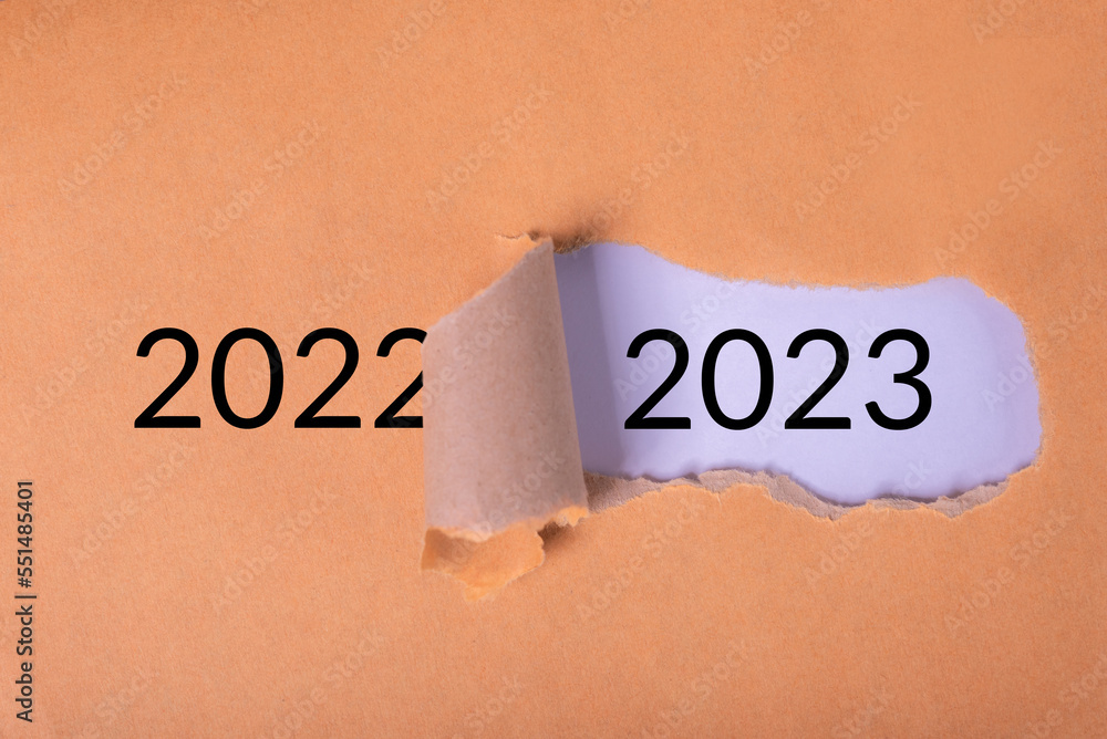 Poster torn piece of paper shows the hole and number 2023