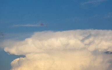 Fluffy white clouds on blue sky.