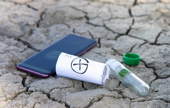 Closeup of geocache log roll and smartphone