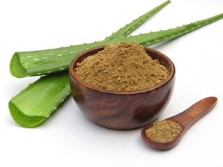 Aloe Vera powder in a bowl with leaf isolated on white background 