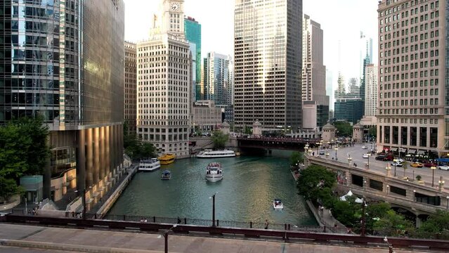 Aerial view of Chicago riverwalk while touristic boat cross the river