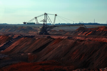 Landscape of industrial view of opencast mining quarry with machinery at work. Area has been mined...