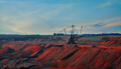Landscape of industrial view of opencast mining quarry with machinery at work. Area has been mined...