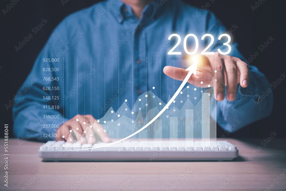 Aufkleber man hand point on growth up arrow of business graph to year 2023