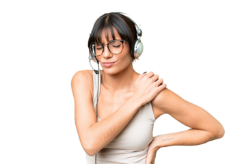 Telemarketer caucasian woman working with a headset over isolated background suffering from pain in shoulder for having made an effort